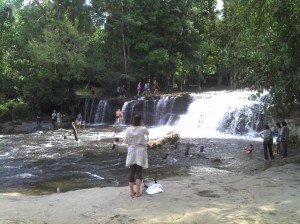 The top level of Phnom Kulen waterfalls. Some people bathe there.
